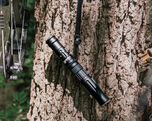 IronBuck hanging from a tree with a blurred forest background