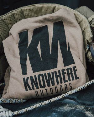 Beige hoodie with 'Knowhere Outdoors' logo on a saddle